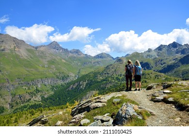 Hikers in the Gran Paradiso National Park. Aosta Valley, Italy. Beautiful mountain landscape in sunny day. - Shutterstock ID 2111010425