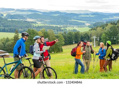 Hikers helping cyclists following track in nature landscape - Powered by Shutterstock