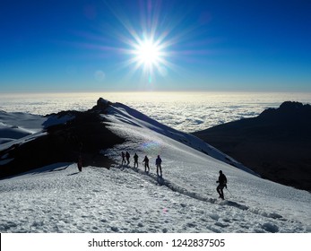Hikers Make Their Way To The Summit Of Mount Kilimanjaro On The Snow