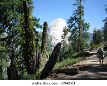 Hikers On The Panorama Trail With Half Dome Visible In The Background In Yosemite National Park, California, USA