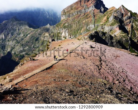 Hikers on ridge trail, Madeira Pico Ruivo trail. Happy hiker winning reaching life goal, success, freedom and happiness, achievement in mountains. Mountains in Sunset.