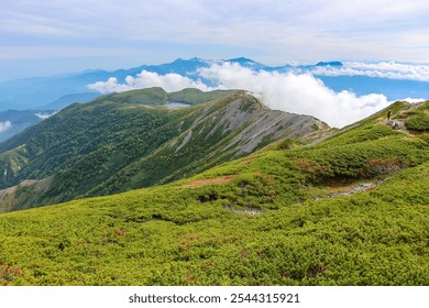 Hikers on a Scenic Mountain Ridge Overlooking a Serene Alpine Lake, Japan - Powered by Shutterstock