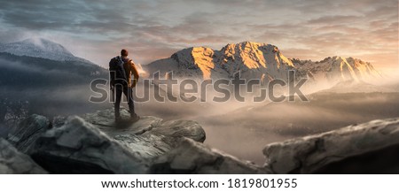 Hikers on a summit in a wintry mountain landscape