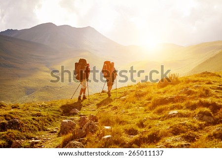 hikers on the trail in the Caucasian mountains. Trek to Kazbek mount