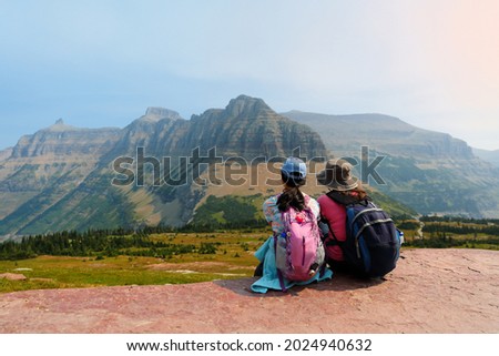 Hikers taking a break along the Logan Pass in Glacier National Park, Montana USA. Logan Pass is located along the Continental Divide in Glacier National Park.