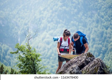 Hikers Using Map To Navigate Outdoor