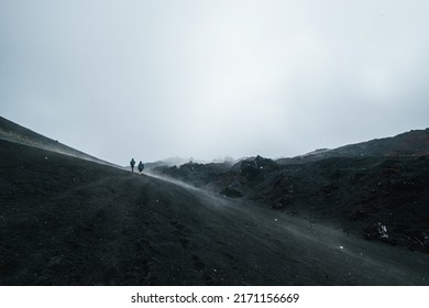 Hikers Walking To Climb The Top Of Volcano Mountain, Hills Of Slag Lava Field