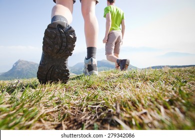 hikers walking in the mountains, close up of the foot, low angle