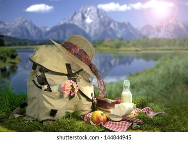 Hiking backpack before backdrop of mountain lake, picnic