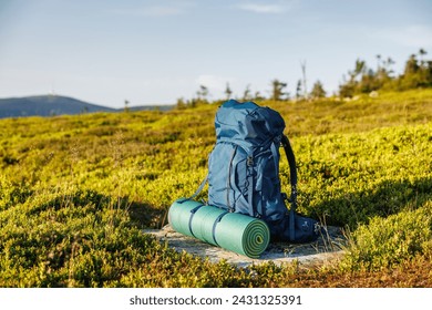 Hiking backpack with mat during trek in mountains. Camping and trekking equipment - Powered by Shutterstock