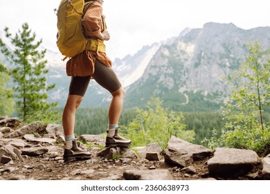 Hiking boot. Close-up of female legs in hiking boots on a hiking trail, on top of a mountain outdoors. Travel, vacation concept. - Powered by Shutterstock