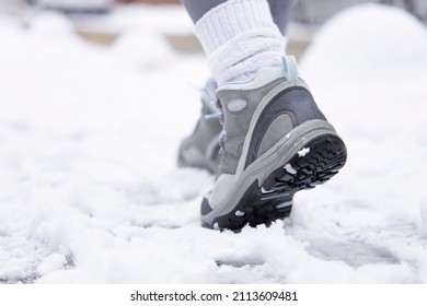 Hiking Boot Close-up, Walking In Snow. Close Up Of Winter Shoes.
