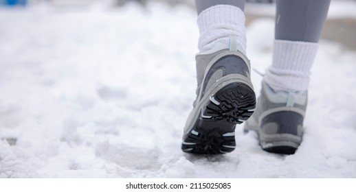 Hiking Boot Close-up, Walking In Snow. Close Up Of Winter Shoes.
