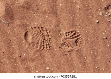 Hiking Boot Footprint In The Red Sand Of The Namib Desert.