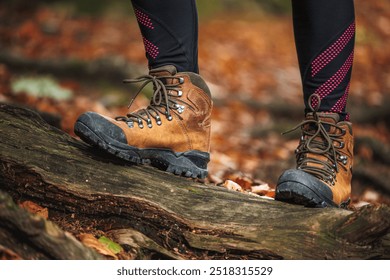 Hiking boot. Legs on mountain trail during trekking in autumn forest - Powered by Shutterstock