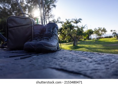 Hiking Boots And Camera Bag On Tailgate With Sunflare