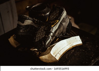 Hiking Boots Drying Over Wood Stove In Rustic Cabin