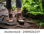 Hiking boots on trekking trail in forest. Outdoor waterproof leather shoes