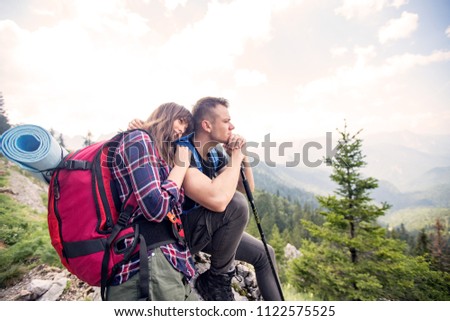 Hiking couple enjoying in view while hiking