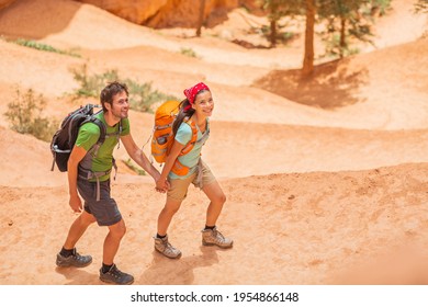 Hiking Couple Hikers Walking In Bryce Canyon National Park Trail Outdoor. Top Aerial View Of Two Adults On Summer Travel Hike Wearing Backpacks.