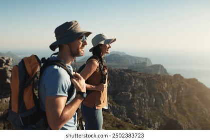 Hiking, couple and mountain on cliff outdoor for fitness travel, adventure view and backpack journey. People, backpacking and trekking together for cardio exercise, rock climbing and health in summer - Powered by Shutterstock