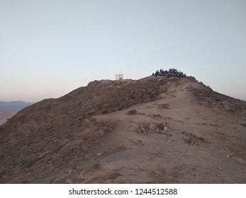 Hiking Desert Part Of Israel National Trail. Negev Desert. Group Watching Sunrise