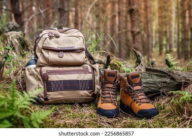 Hiking equipment in forest. Backpack and leather ankle boots - Powered by Shutterstock