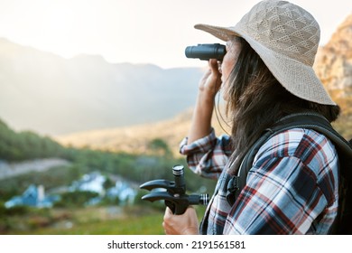 Hiking, Exploration And Mountain Adventure With Binoculars, Trekking Pole And Walking Aid In A Remote Landscape With View. Mature Woman, Hiker And Tourist Watching Birdlife Or Wildlife In Eco Nature