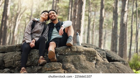 Hiking, forest and nature couple people on rock for journey, adventure or wellness lifestyle with trees, fitness gear and backpack. Trekking, relax and diversity friends travel in mountains or woods - Powered by Shutterstock