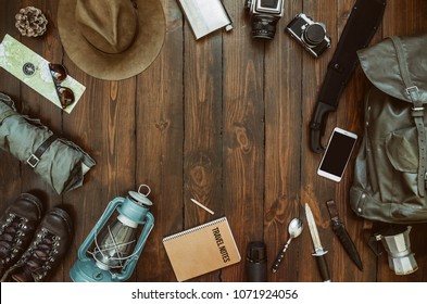 Hiking gear frame including backpack machete, knife, clothes, boots, lantern, camera, hat, map, compass. Packing for a hike concept. Wanderlust, safari equipment postcard, poster, banner background. - Shutterstock ID 1071924056