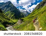 Hiking Group In Valley Of Umbalfaelle On Grossvenediger With View To Mountain Roetspitze In Nationalpark Hohe Tauern In Tirol In Austria