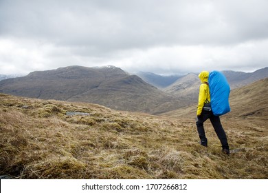 Hiking In The Highlands With Rain Jacket And Backpack 