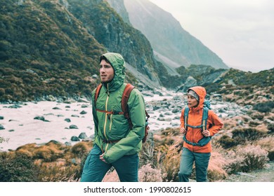 Hiking - hikers on trek with backpacks living healthy active lifestyle. Hiker girl walking on hike in mountain nature landscape
