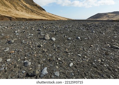 Hiking in Iceland rugged rocky black volcanic sediment landscape in Seljavallalaug - Powered by Shutterstock