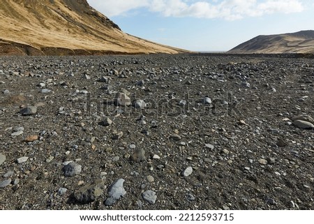 Hiking in Iceland rugged rocky black volcanic sediment landscape in Seljavallalaug