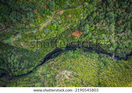 Hiking Levada trail 25 Fontes in Laurel forest - Path to the famous Twenty-Five Fountains in beautiful landscape scenery - Madeira Island, Portugal. October 2021. Aerial drone shot