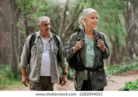 Hiking, looking and senior couple in nature for exercise, holiday walking and enjoying the mountains. Travel, retirement and an elderly man and woman on a walk in the woods or forest for trekking