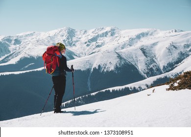 Hiking - Male Hiker With Backpack Admiring The View With Snow-capped Mountains In Winter / Early Spring In Romania, Iezer-Papusa Mountains