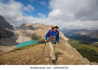 Hiking Man In Canadian Mountains. Hike Is The Popular Recreation Activity In North America. There Are A Lot Of Picturesque Trails.