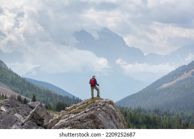 Hiking Man In Canadian Mountains. Hike Is The Popular Recreation Activity In North America. There Are A Lot Of Picturesque Trails.