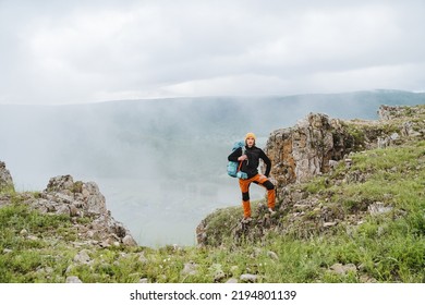 Hiking In The Mountains, A Guy Walks On Rocky Terrain With A Backpack, A Hike To The Top Of The Mountain, A Morning In The Fog, A Person Actively Rests, A Sports Hike.