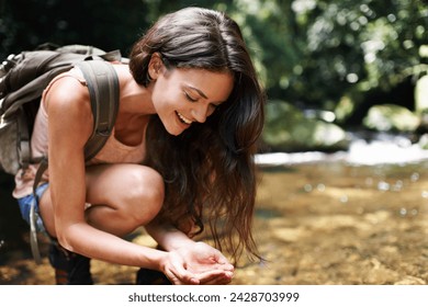 Hiking, nature and woman by river drinking for thirst on adventure, trekking and explore outdoors. Travel, camping and person by lake, stream or water for wellness on holiday, vacation and journey - Powered by Shutterstock