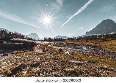 Hiking Near An Epic Mountain Range In Glacier National Park While On A Camping Vacation