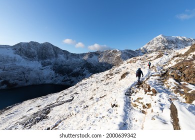 Hiking On Pyg Track Climbing Mount Snowdon, Snowcaped Snowdonia, North Wales In The Sun And Snow