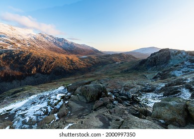 Hiking On Pyg Track Climbing Mount Snowdon, Snowcaped Snowdonia, North Wales In The Sun And Snow