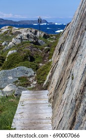 Hiking Path By Flat Flat Rock Face Along Newfoundland Coast; Icebergs