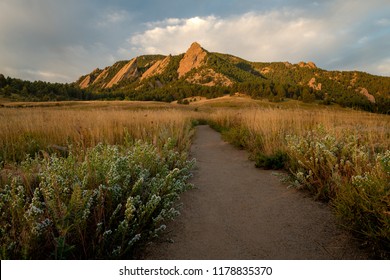A hiking path leads to the Flatiron Mountains and adventure in Boulder Colorado's Chautauqua Park.