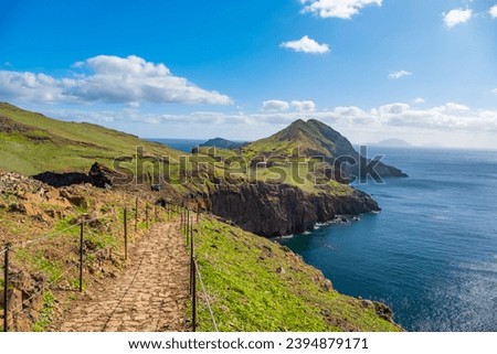 Hiking path on Ponta de Sao Lourenco Madeira Portugal. Scenic mountain view of green landscape cliffs and Atlantic Ocean. Ative day, travel background