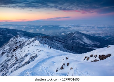 Hiking People In The Mountains Snow Winter Evening In Europe. 
Kasprowy Wierch, Tatra Mountian, Poland