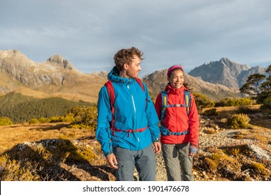 Hiking People Walking Living Healthy Outdoor Active Lifestyle Doing Hike At Routeburn Track. Multiethnic Hikers With Backpacks Are Tramping On Key Summit Track At Fiordland National Park, New Zealand.